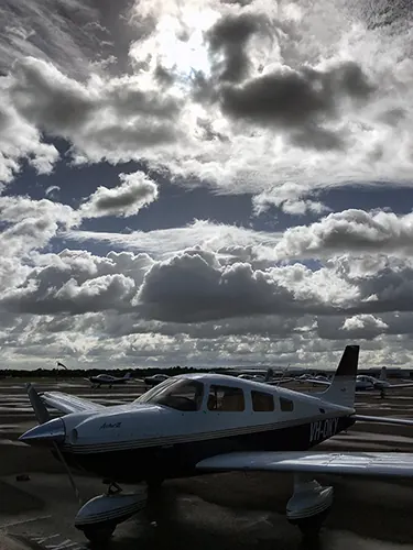 VH-OKY under a dramatic cloudscape